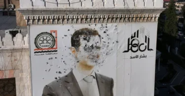 A bullet-riddled portrait of Syrian President Bashar al-Assad, which adorned the Hama municipality building, after it was defaced following the capture of the city by rebel fighters, Dec. 6, 2024. (Credit: Omar Haj Kadour/AFP)