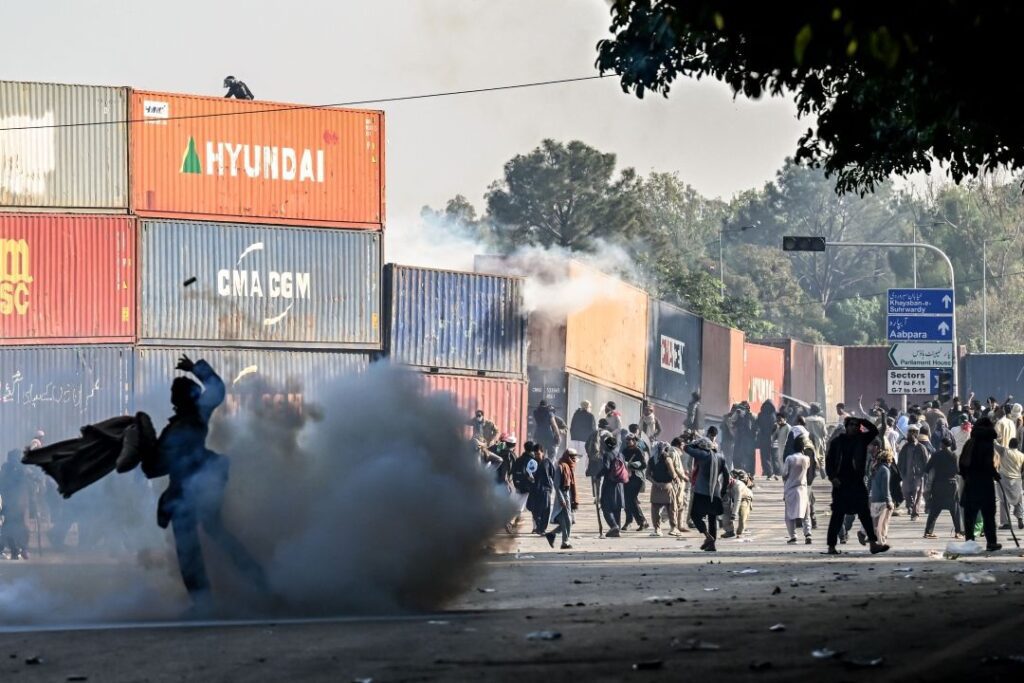 Policemen fire tear gas shells to disperse supporters of the Pakistan Tehreek-e-Insaf (PTI) party during a protest demanding the release of former prime minister Imran Khan [photo: AFP]