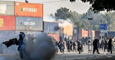 Policemen fire tear gas shells to disperse supporters of the Pakistan Tehreek-e-Insaf (PTI) party during a protest demanding the release of former prime minister Imran Khan [photo: AFP]