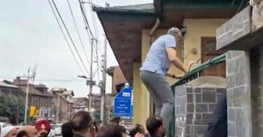 Jammu and Kashmir Chief Minister Omar Abdullah scales the gate of the Naqshband Sahib graveyard in Srinagar, July 14, 2025, to pay tributes to the July 13, 1931 martyrs. Photograph: OmarAbdullah/X