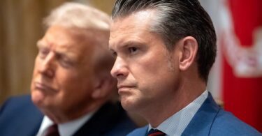 Defense Secretary Pete Hegseth and President Donald Trump listen during a Cabinet meeting at the White House, Aug. 26, 2025. | Mark Schiefelbein/AP