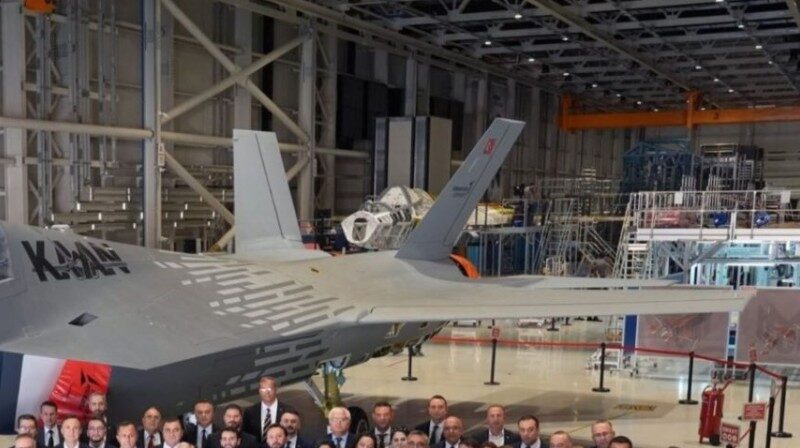 A crop of the original image showing the skeletal airframe of the second Kaan prototype, P1, seen in the TAI facility behind the current flying example, P0. (Image credit: Turkish Armed Forces Foundation)