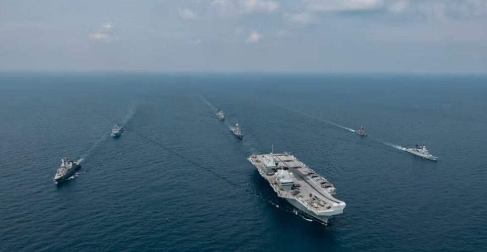 Aerial image of the Carrier Strike Group during Ex BERSAMA LIMA 2025 off the Malaysian coast, with HMS Prince of Wales at the helm. | UK MOD Crown copyright