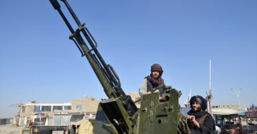 Taliban fighters use an anti-aircraft gun during clashes. (AFP)
