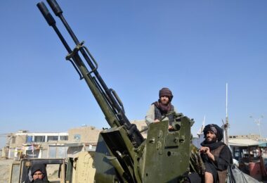 Taliban fighters use an anti-aircraft gun during clashes. (AFP)