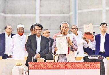 Chief Adviser Mohammad Yunus holds up the July Charter, flanked by leaders of different political parties, including BNP Secretary-General Mirza Fakhrul Islam Alamgir, after the signing of the Charter at a grand event on the Parliament premises in the city on 17 October 2025.