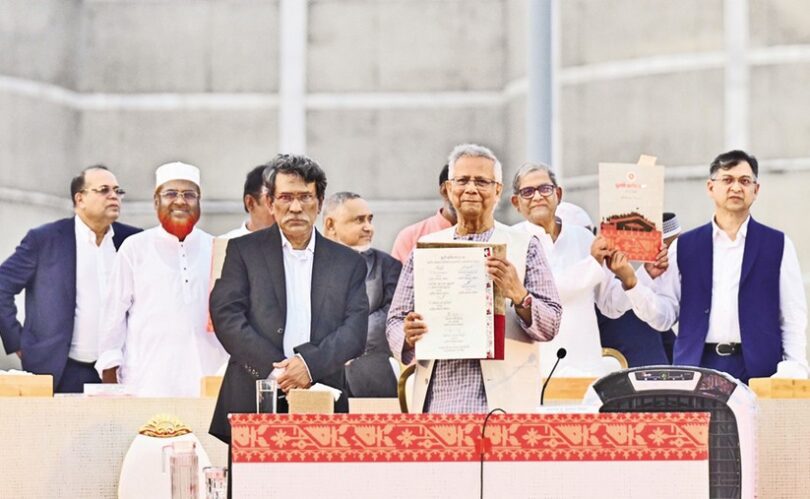 Chief Adviser Mohammad Yunus holds up the July Charter, flanked by leaders of different political parties, including BNP Secretary-General Mirza Fakhrul Islam Alamgir, after the signing of the Charter at a grand event on the Parliament premises in the city on 17 October 2025.