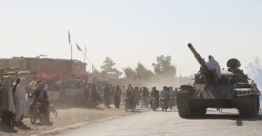 An Afghan Taliban fighter sits on a tank near the Afghanistan-Pakistan border in Spin Boldak, Kandahar Province, following exchanges of fire between Pakistani and Afghan forces in Afghanistan. Reuters